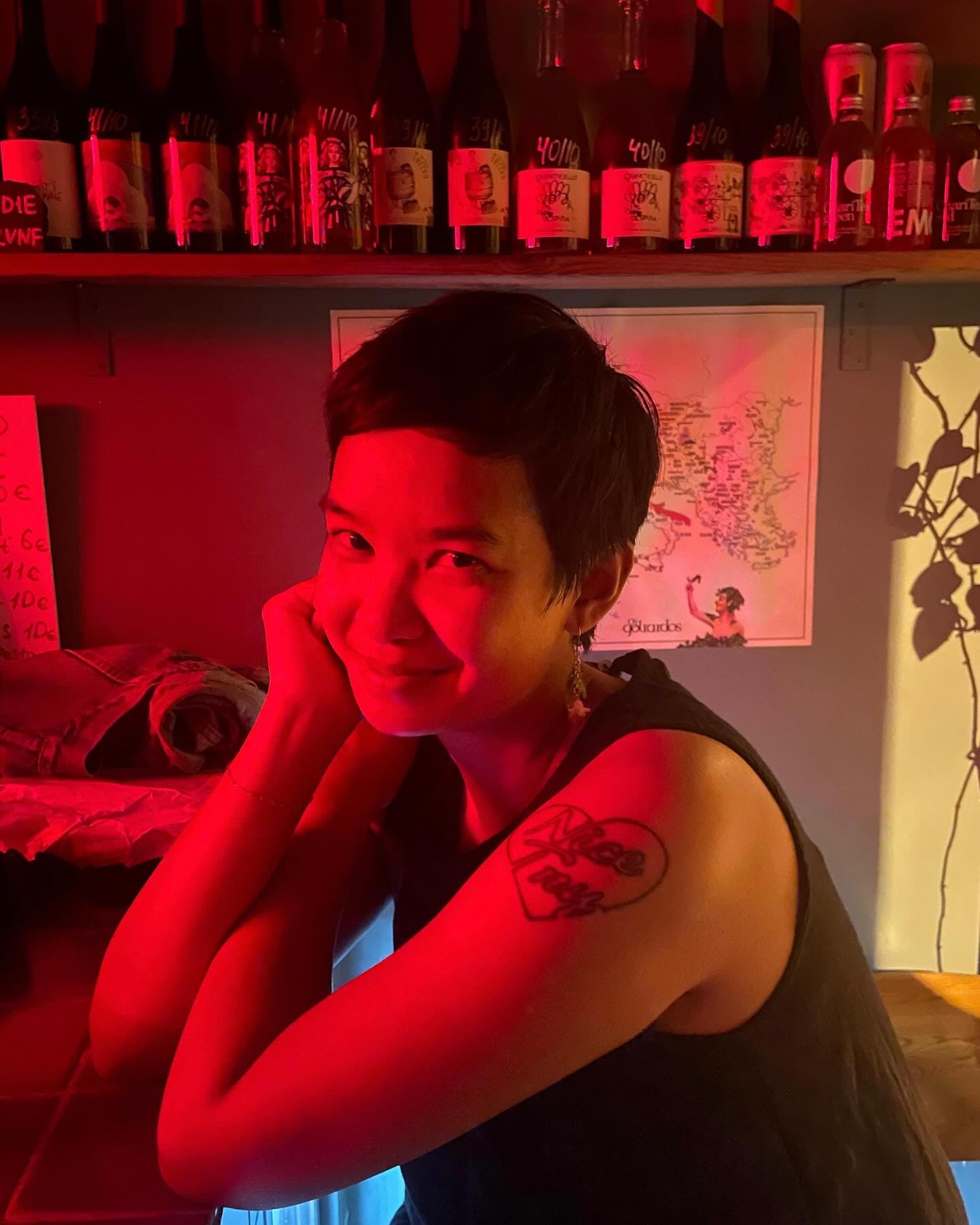 Frankie Tran smiling in a red-lit room.